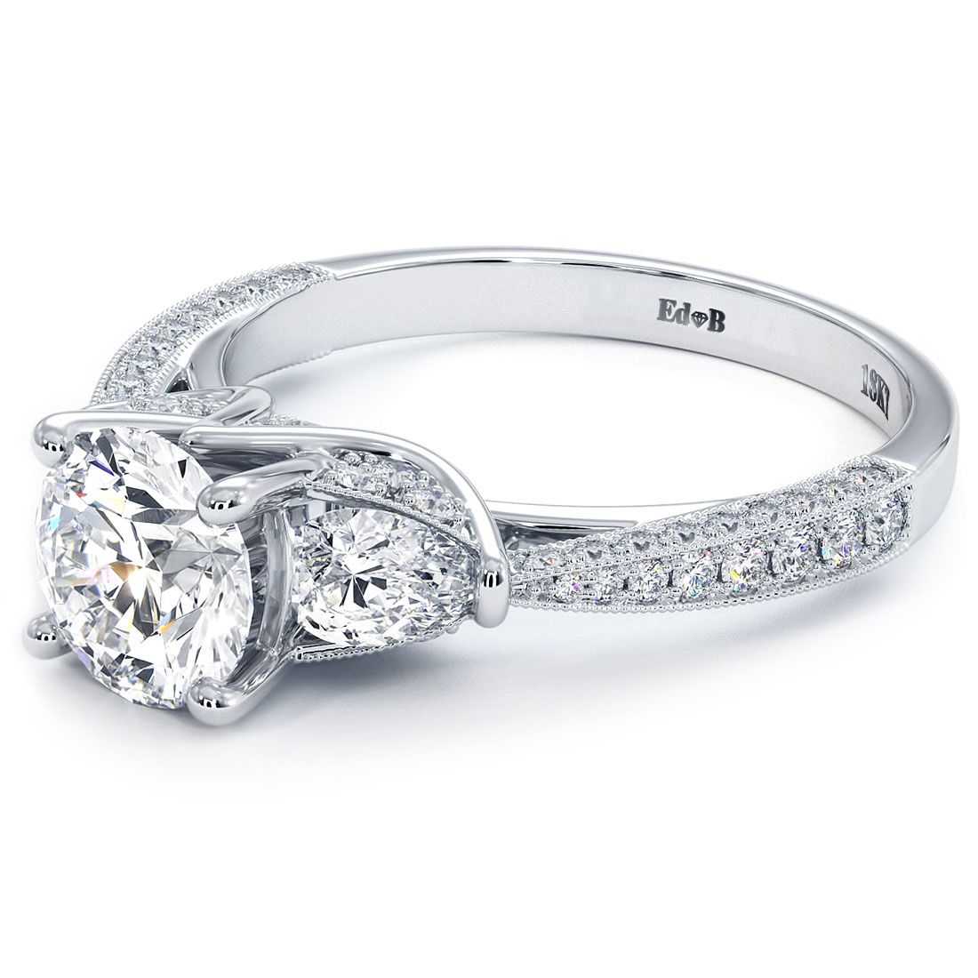 Close-up of three stone round cut diamond engagement ring in white gold with antique milgrain design | Diamond District