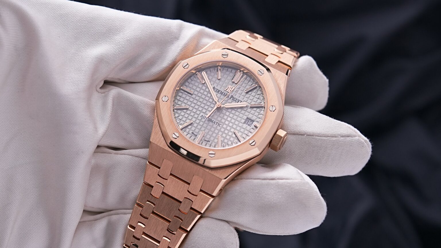 Angled shot of Audemars Piguet Royal Oak 37mm rose gold with nickel grey dial and bracelet – full set brand new watch available at Global Sky Diamonds – globalskydiamond.com