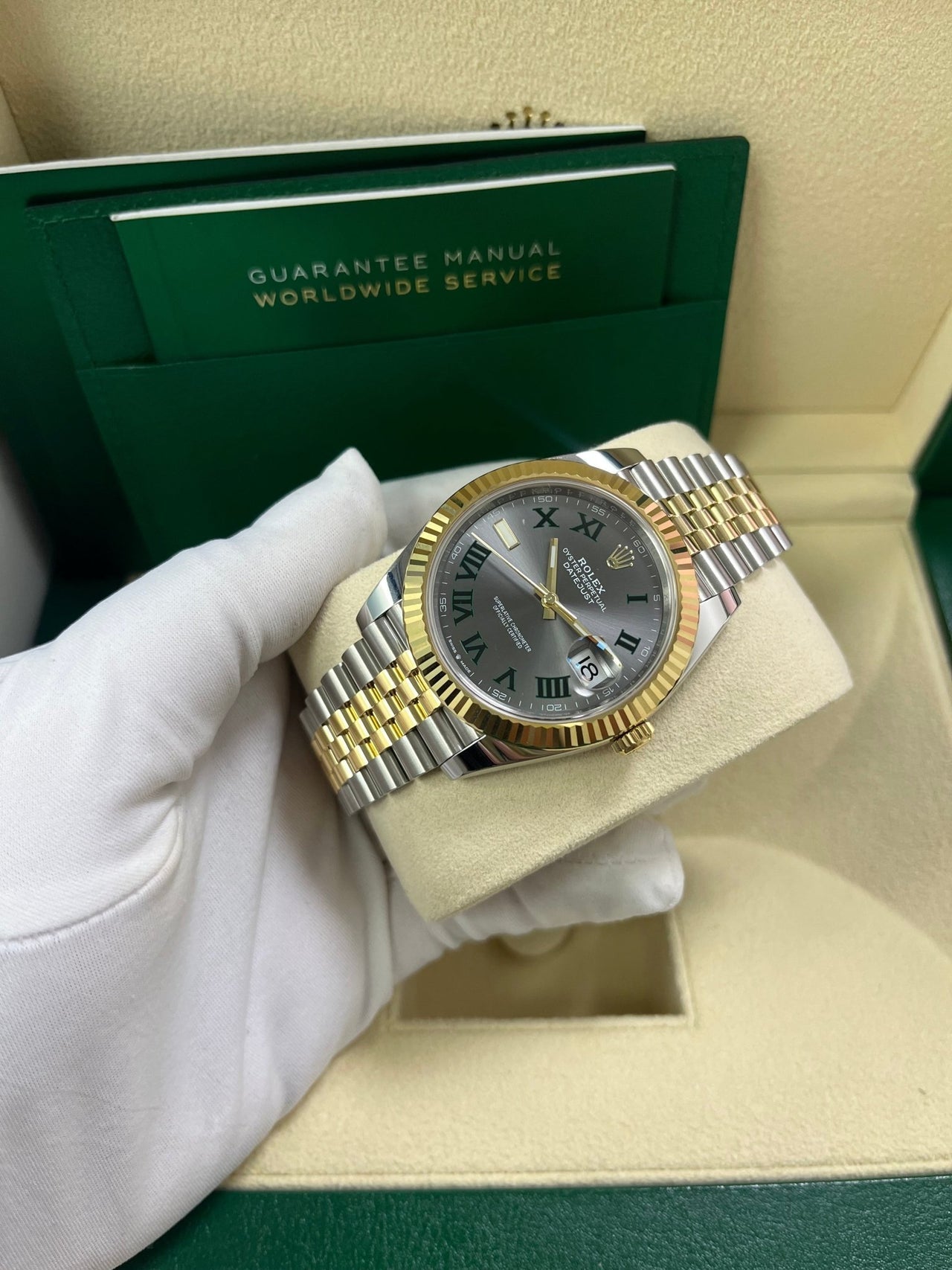 Angled shot of Rolex Datejust 41mm yellow Rolesor model with Jubilee bracelet and Oyster clasp – grey dial Rolex 126333 pre-owned like-new for $15,500 from Global Sky Diamonds – globalskydiamond.com