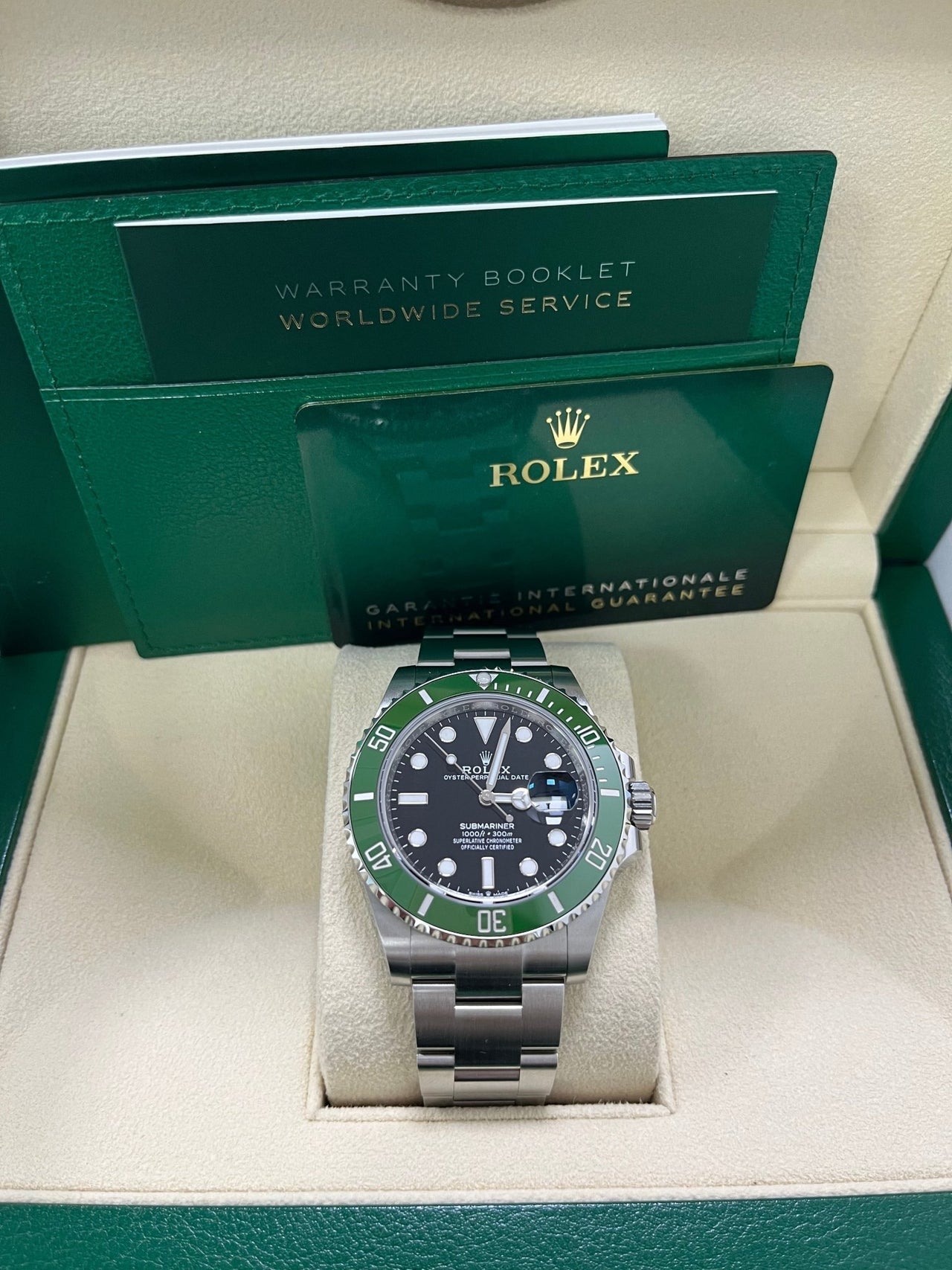 Display of full Rolex Submariner 126610LV set including box, warranty card, and booklet – like-new 2025 green bezel Rolex for $13,000 at Global Sky Diamonds – globalskydiamond.com