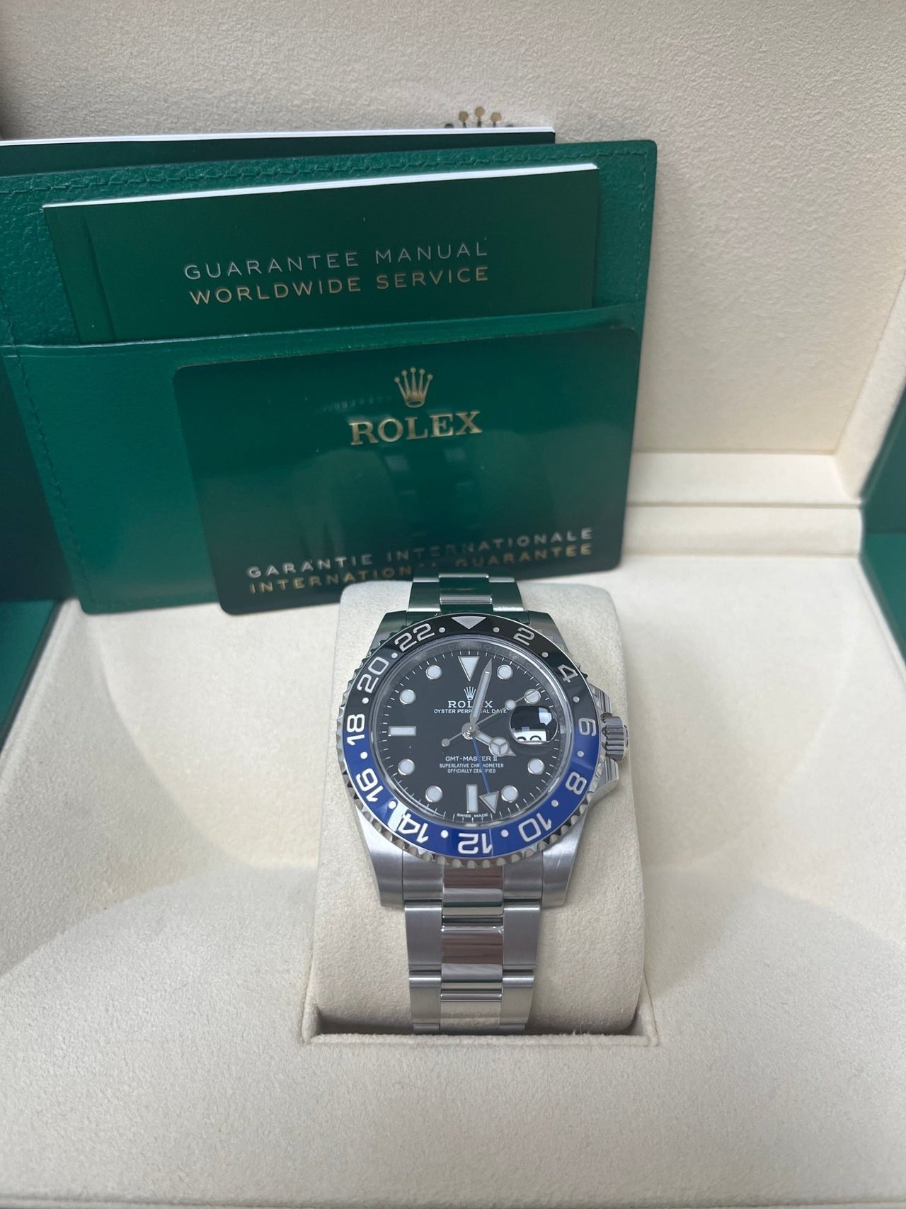 Display of Rolex GMT-Master II Batman 116710BLNR complete set with box, warranty card, and booklet – pre-owned Rolex 2018 available for $14,500 at Global Sky Diamonds – globalskydiamond.com