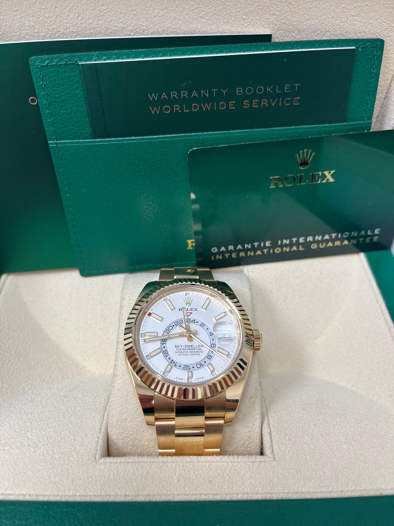 Complete set display of Rolex Sky-Dweller white dial with box, warranty card, and certificate – pre-owned but brand new 2025 Rolex at Global Sky Diamonds – globalskydiamond.com