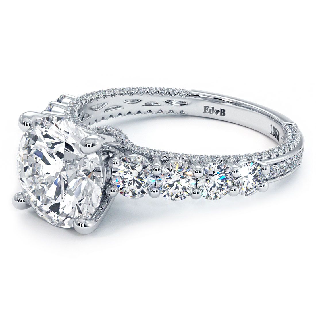 Angled close-up of Round Brilliant engagement ring setting with dazzling 1.45ctw micropavé and graduated side diamonds, expertly crafted in 18k white gold for a 2.0ct round center stone (not included), featuring G color SI1 clarity, by Global Sky Diamonds, NYC, 44W 47th St Booth GF-10. Shop now at GlobalSkyDiamond.com.