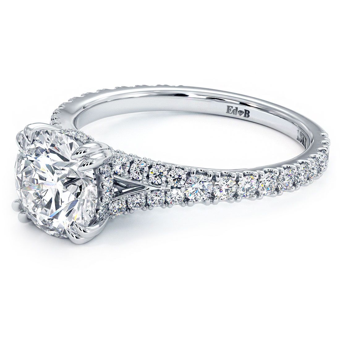 Angled close-up of Infinity Twist Round Halo Diamond Engagement Ring Setting in 18k white gold with claw prong, pavé diamond band, and split shank detail, expertly crafted by Global Sky Diamonds at 44W 47th St Booth GF-10, New York City. Discover brilliance at globalskydiamond.com