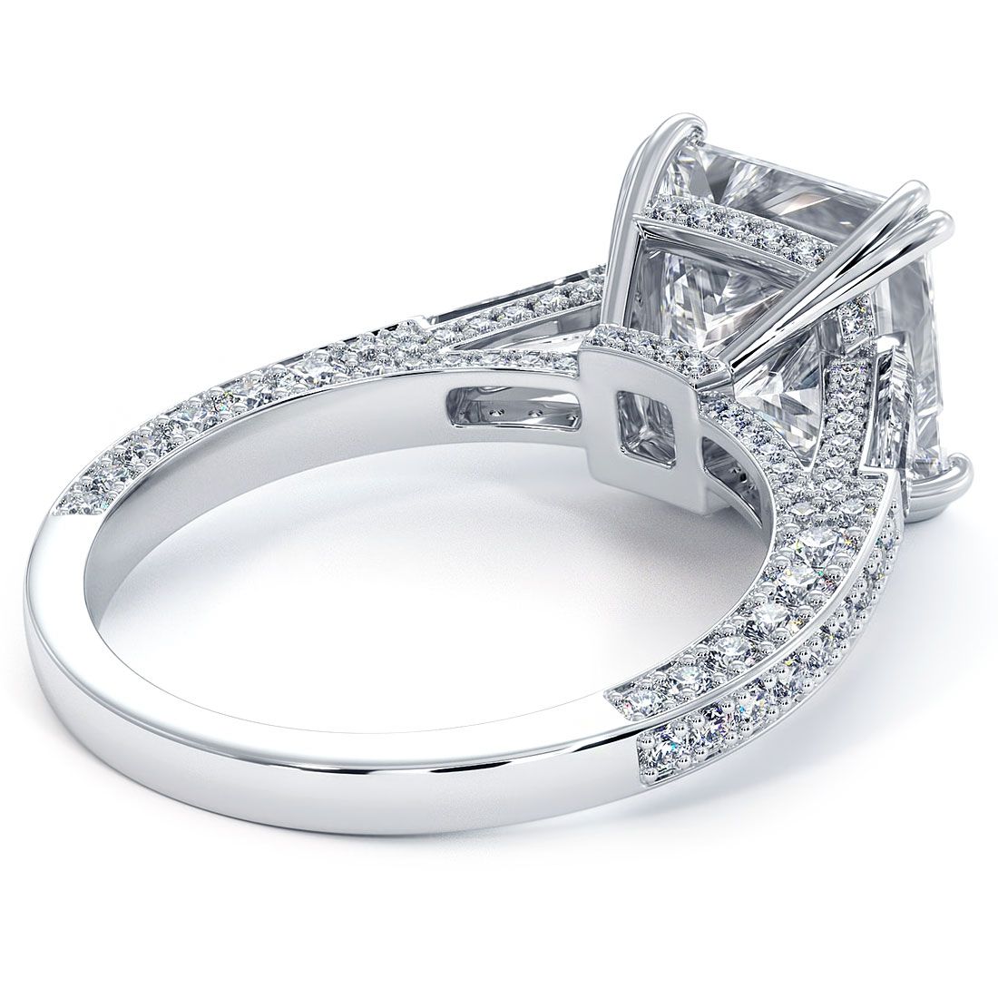 Detailed under-gallery shot of princess cut engagement ring setting in 18KT white gold, featuring tapered baguettes and pavé diamonds on a split shank. Crafted for a 3.0ct center stone with SI1 clarity, G color side stones. Designed by Global Sky Diamonds, Diamond District NYC, 44W 47th St Booth GF-10. globalskydiamond.com @globalskydiamonds @global.sky.diamond