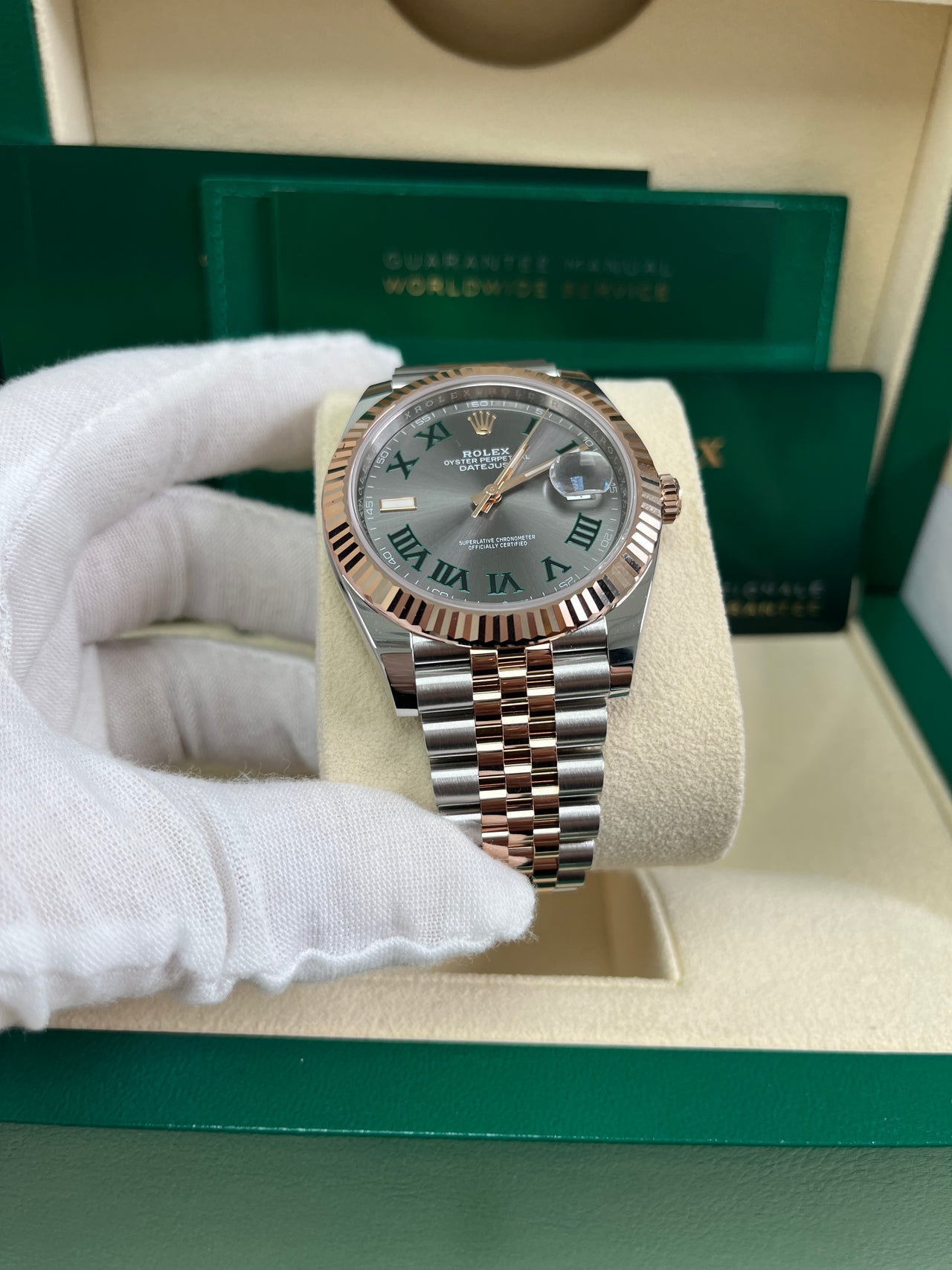 Angled shot of Rolex Datejust 41mm Everose Rolesor model with Jubilee bracelet, Oyster clasp, and Wimbledon Roman dial – pre-owned 2025 Rolex 126331 for $17,500 from Global Sky Diamonds – globalskydiamond.com