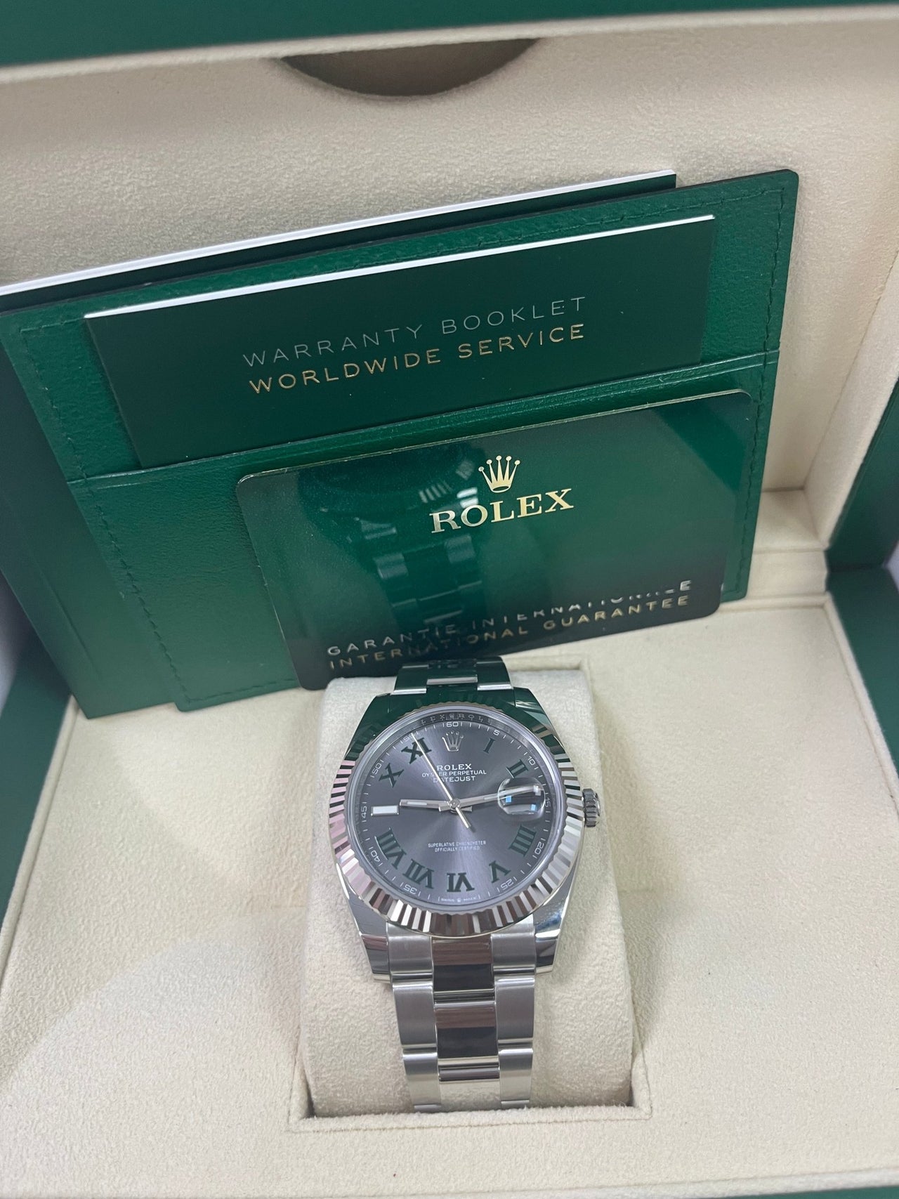 Close-up of Rolex Datejust 126334 with grey sunray dial, luminous hour markers, and sapphire crystal – pre-owned Rolex in mint 2025 condition with fluted bezel and Oyster bracelet – globalskydiamond.com