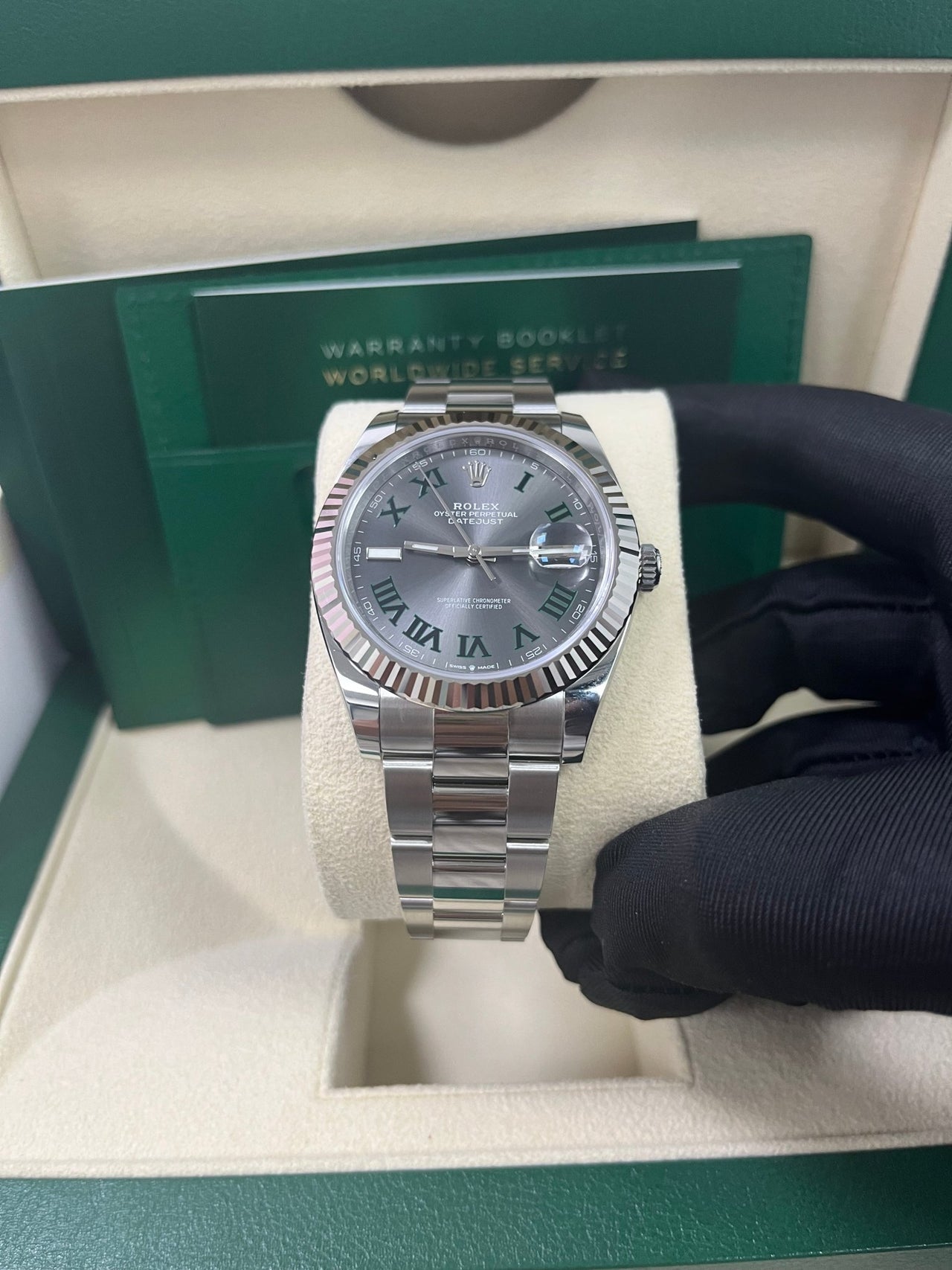 Close-up of Rolex Datejust 126334 with grey sunray dial, luminous hour markers, and sapphire crystal – pre-owned Rolex in mint 2025 condition with fluted bezel and Oyster bracelet – globalskydiamond.com