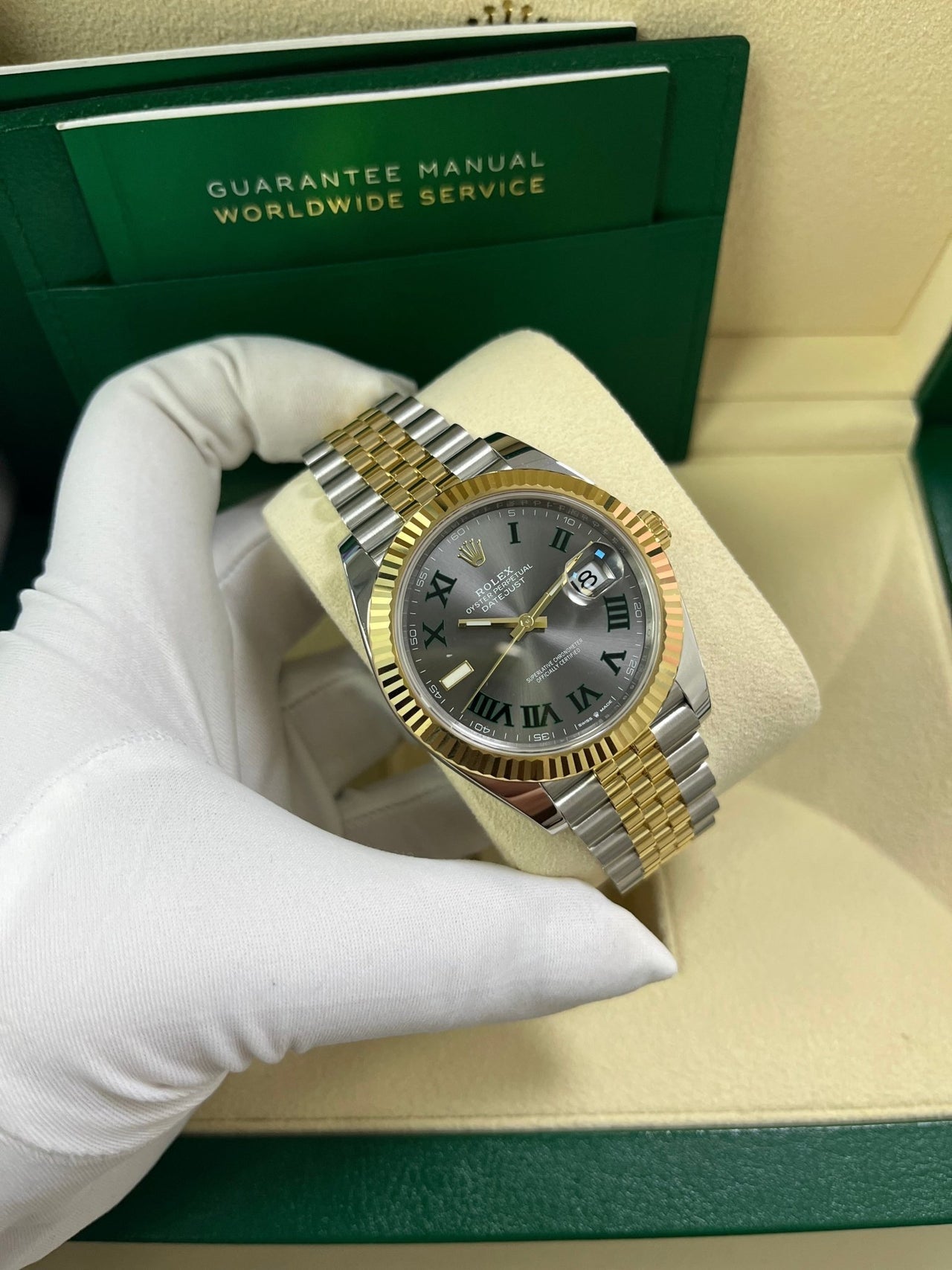 Angled shot of Rolex Datejust 41mm yellow Rolesor model with Jubilee bracelet and Oyster clasp – grey dial Rolex 126333 pre-owned like-new for $15,500 from Global Sky Diamonds – globalskydiamond.com