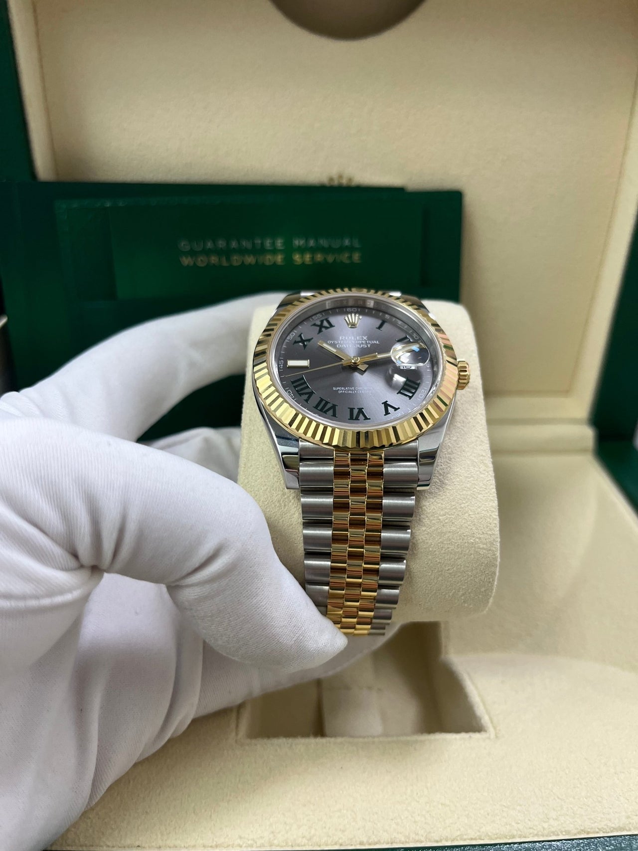 Angled shot of Rolex Datejust 41mm yellow Rolesor model with Jubilee bracelet and Oyster clasp – grey dial Rolex 126333 pre-owned like-new for $15,500 from Global Sky Diamonds – globalskydiamond.com