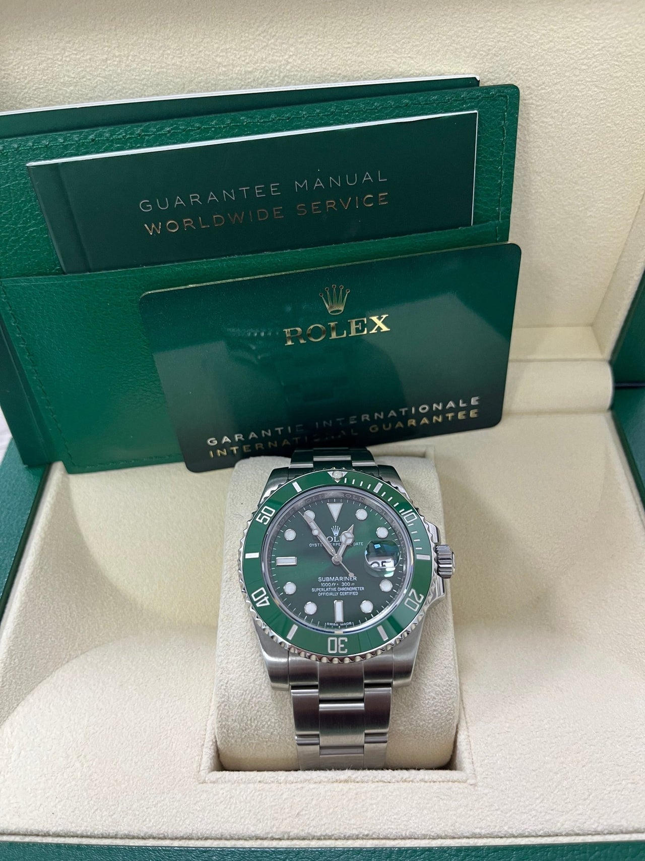 Display of complete Rolex Submariner Hulk 116610LV full set including box, card, and booklet – like-new 2018 green Submariner available now from Global Sky Diamonds – globalskydiamond.com